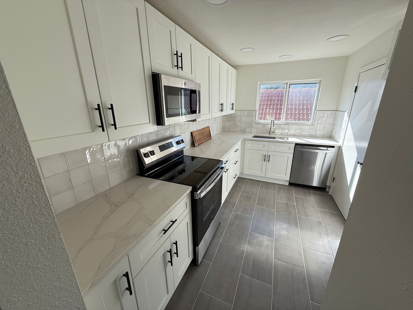 Remodeled white kitchen in Austin with new cabinetry and appliances